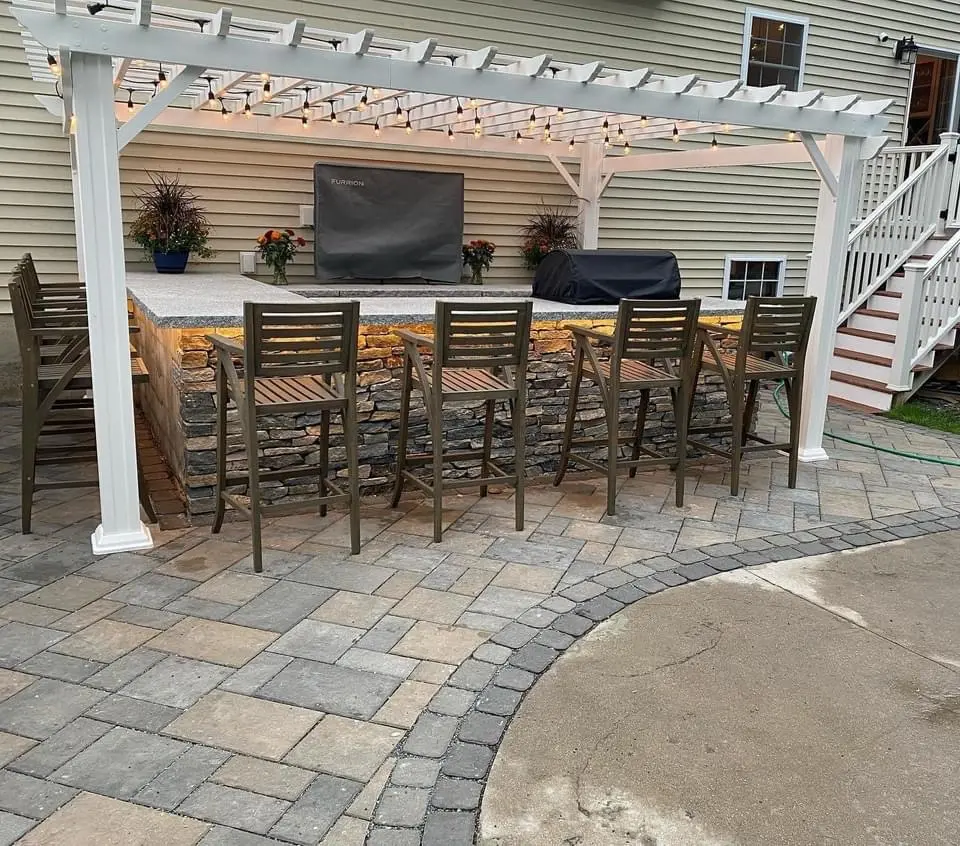 Outdoor kitchen with bar and pergola